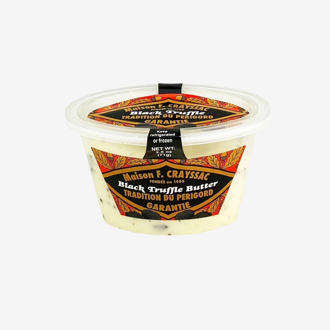 Frozen Black Truffle Butter in a labeled container, showcasing rich ingredients and French culinary tradition.