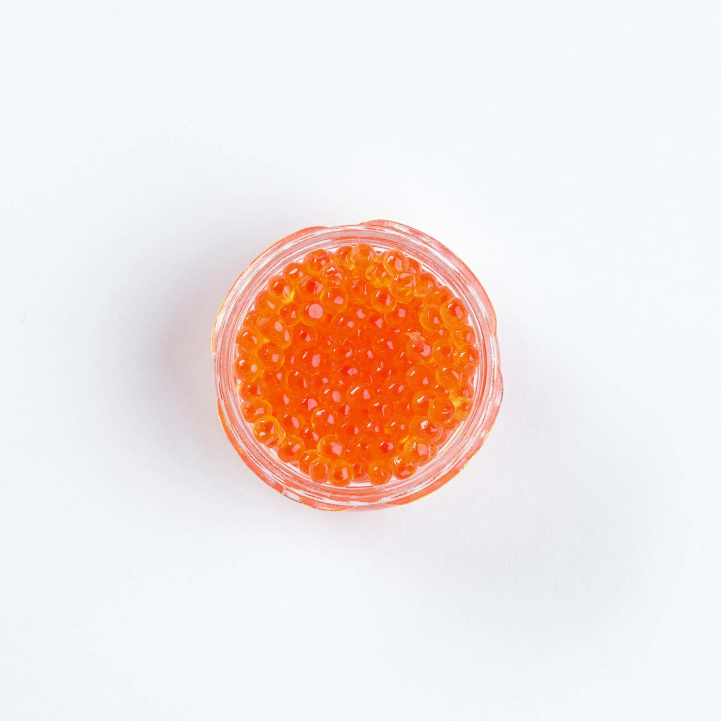 Top view of Keta smoked salmon roe in a clear dish, perfect for enhancing sushi.