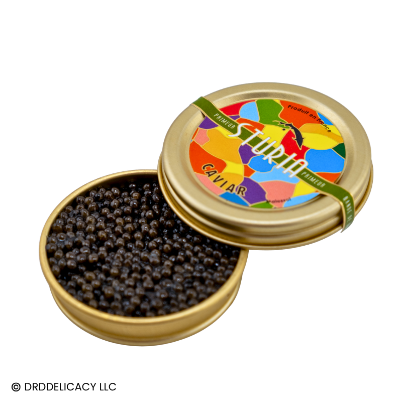 Sturia Siberian Primeur Caviar in a golden tin showcasing dark amber pearls with vibrant colorful packaging.