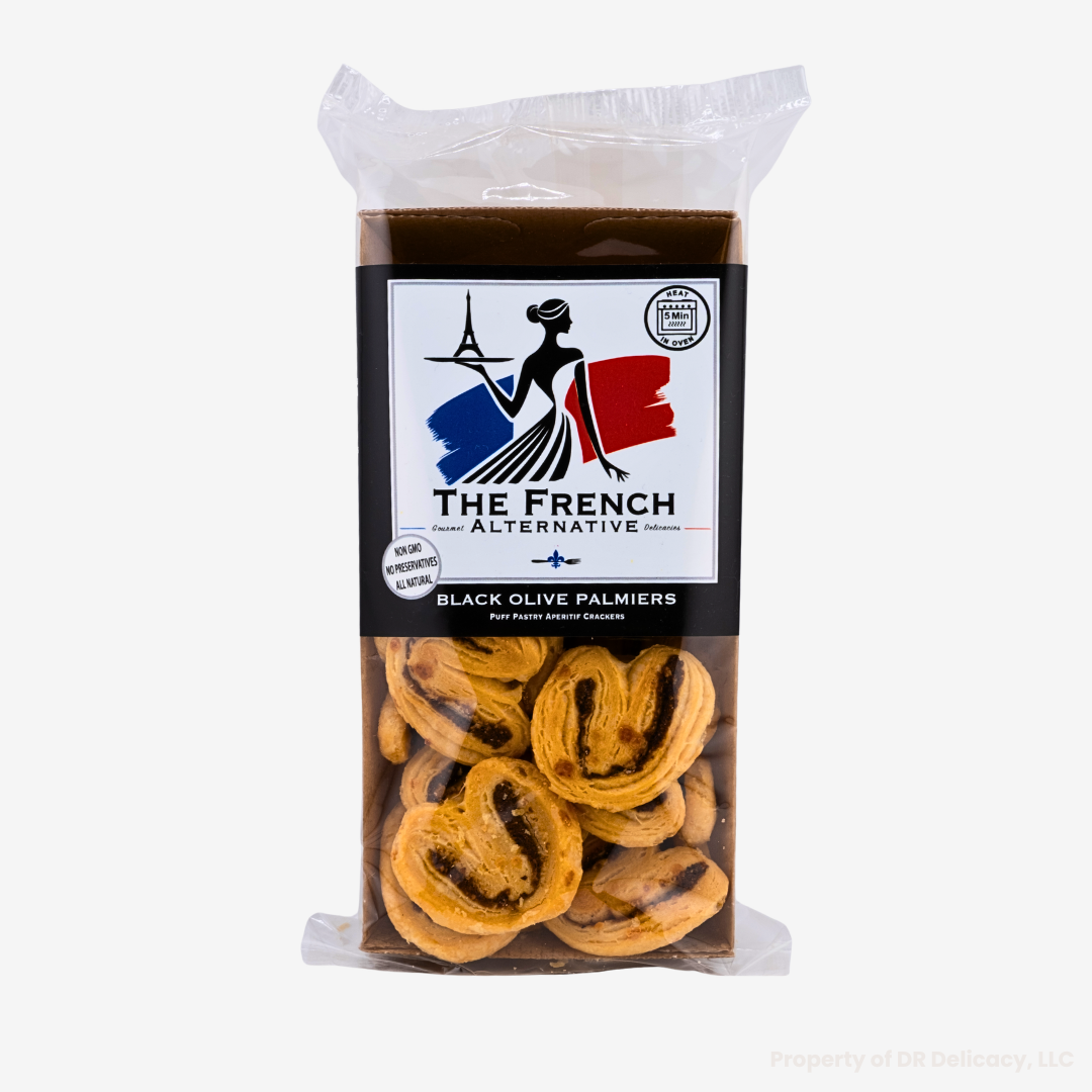 Black Olive Palmier Crackers in a clear package, showcasing flaky puff pastry and rich black olives.