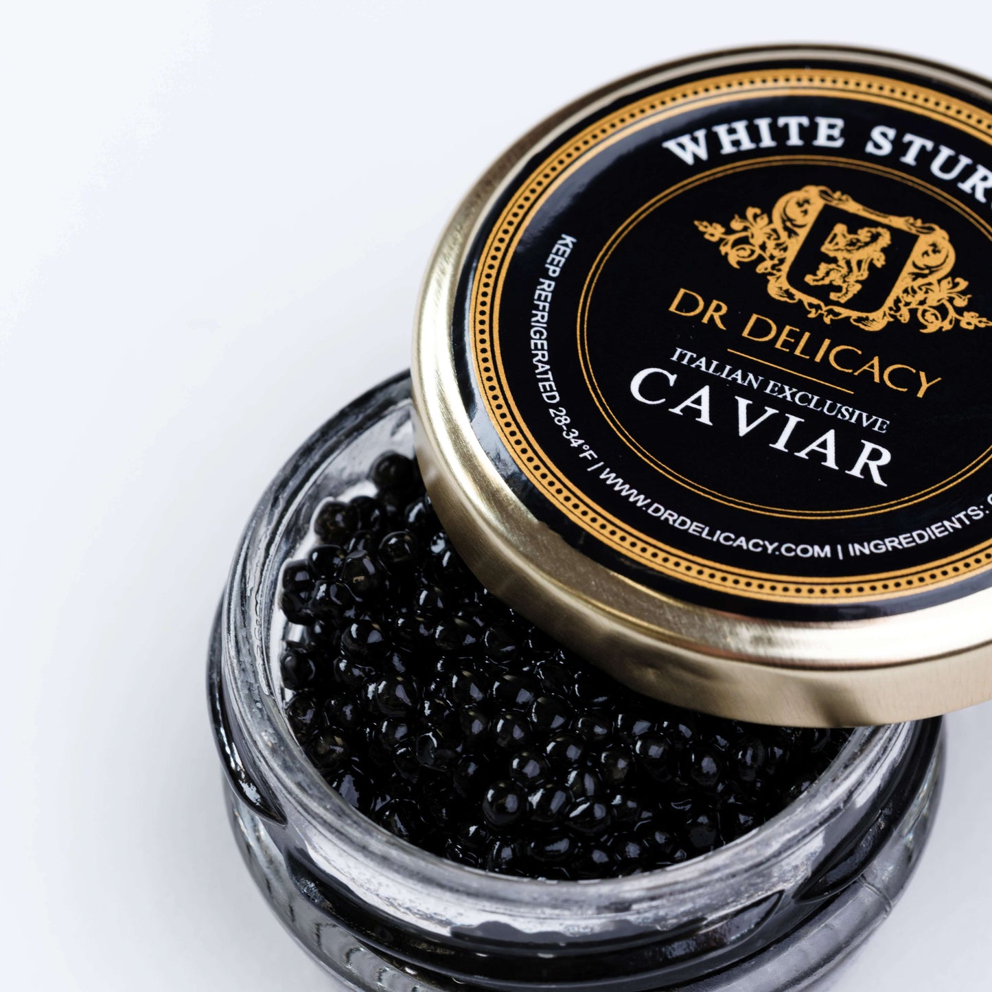 Jar of Italian White Sturgeon caviar with firm black pearls, showcasing luxurious flavor and creamy texture.