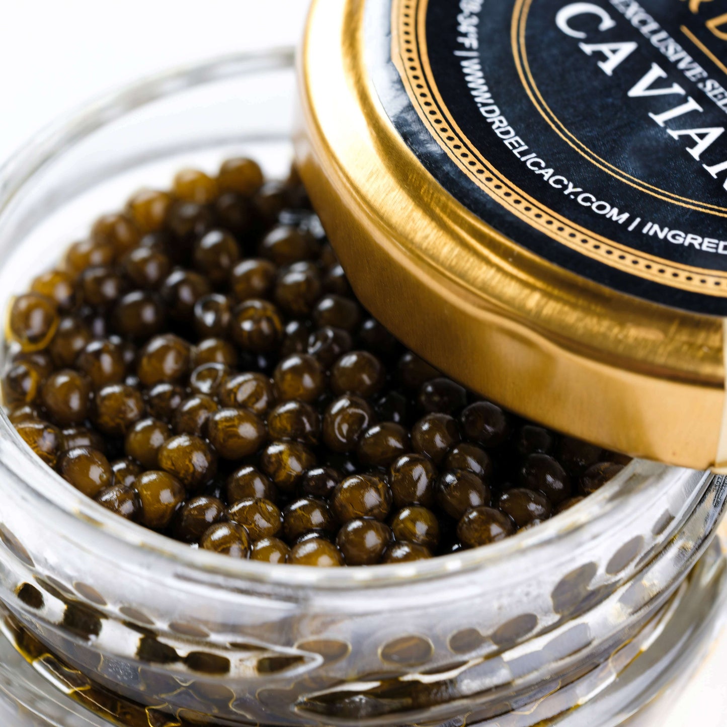 Kaluga Amber Caviar in a jar, showcasing rich amber pearls with a glossy finish.