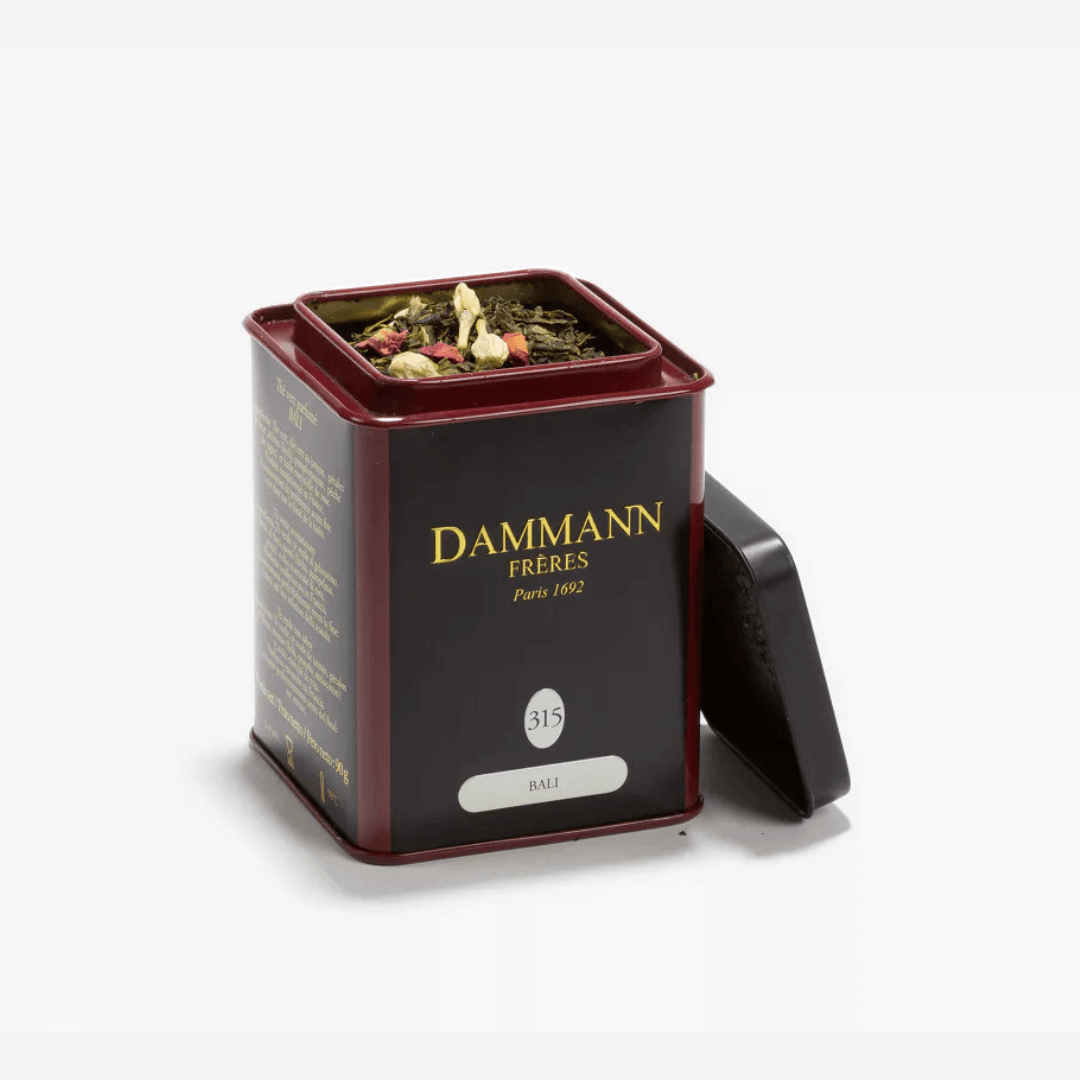 Damman Freres Bali Green Tea tin with loose leaf tea and floral herbs, showcasing elegant packaging.