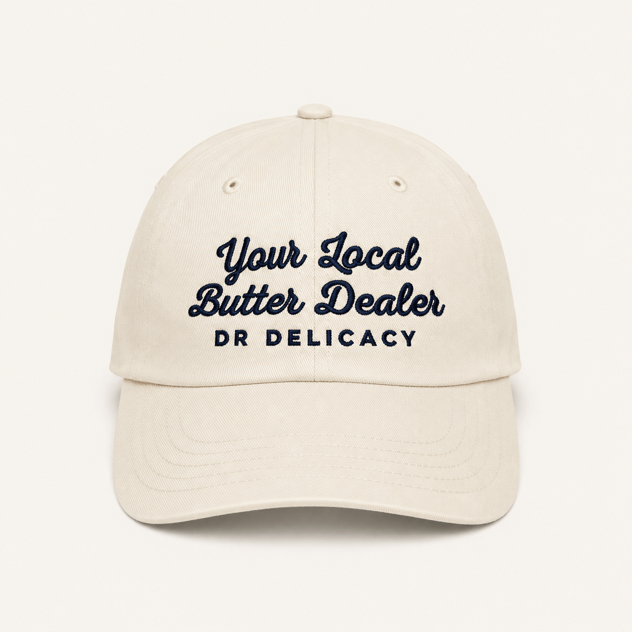 Butter Embroidered Hat featuring 'Your Local Butter Dealer' and DR Delicacy logo in blue embroidery on a stone-washed cap.