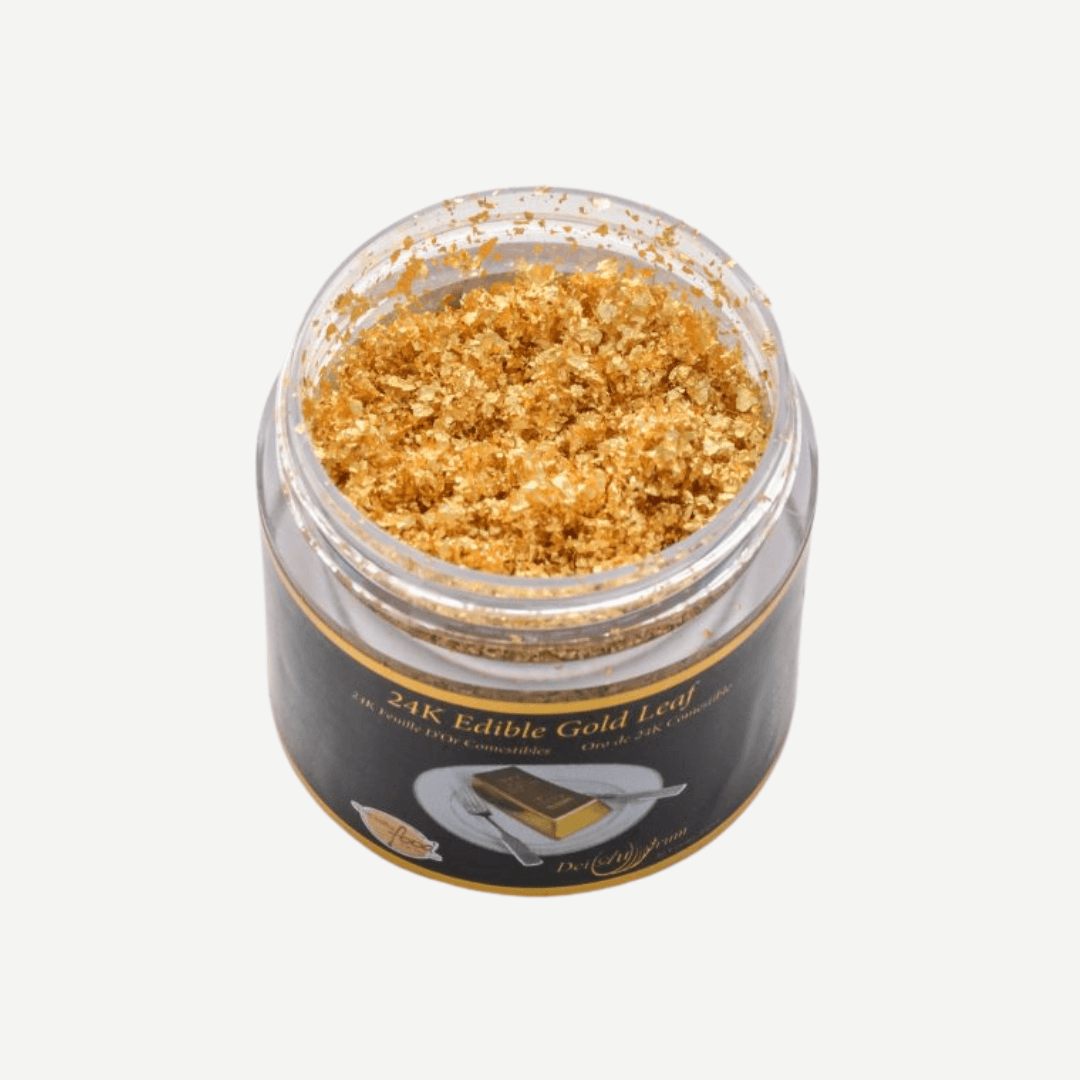 Jar of 24K edible gold leaf crumbs, perfect for adding luxury to food and beverages.
