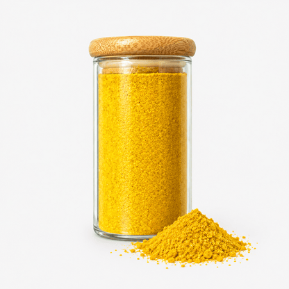 Golden Milk Spice Mix – Turmeric & Cinnamon Blend in a jar with a wooden lid, showcasing the vibrant yellow spice.