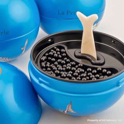 La Perle Caviar Gift Set featuring premium Kaluga Hybrid caviar and a mother-of-pearl spoon in elegant packaging.