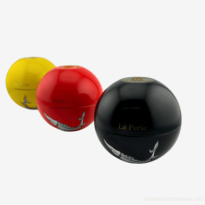 La Perle Caviar Gift Set three elegantly packaged caviar jars in yellow, red, and black.