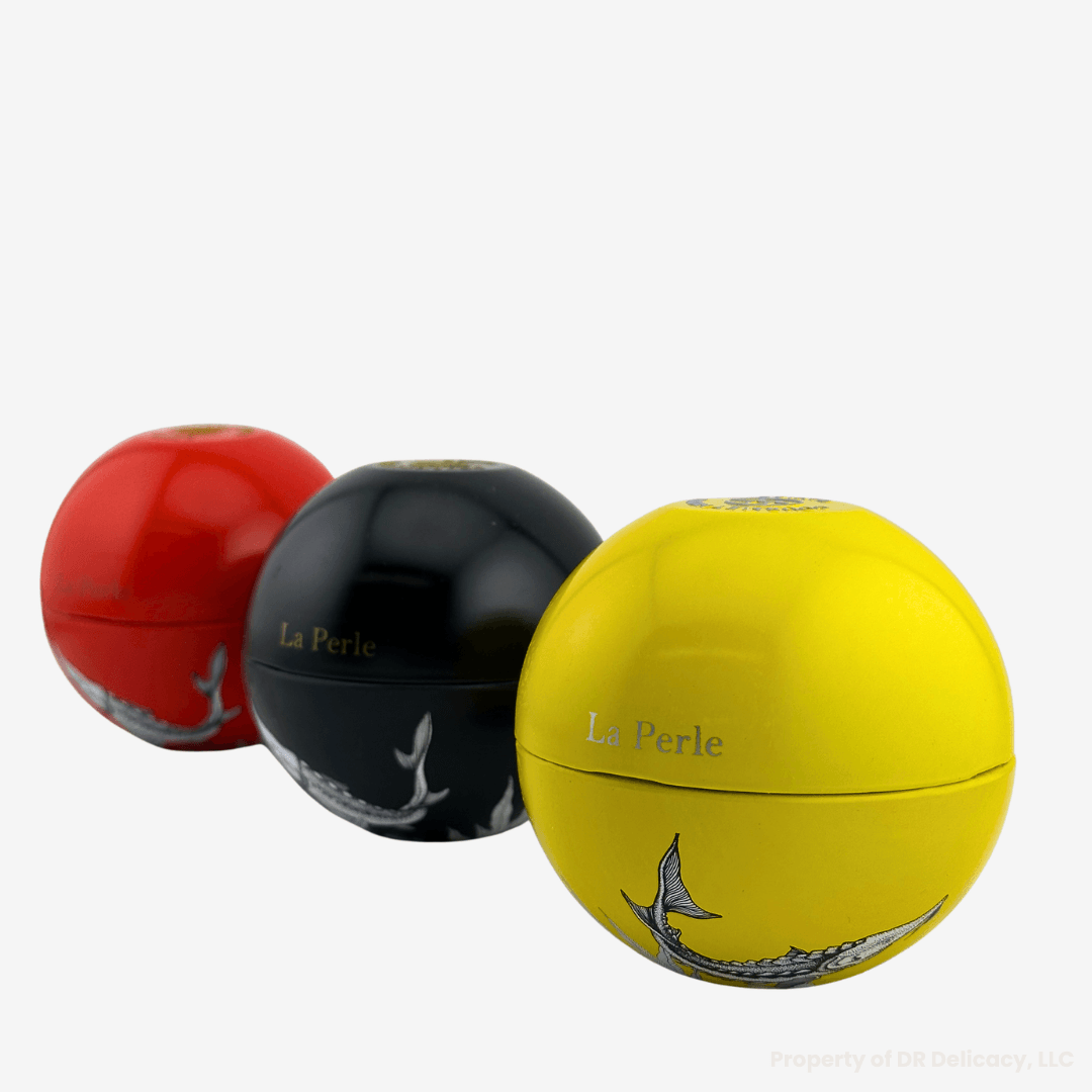 La Perle Caviar Gift Set featuring three colorful spheres in red, black, and yellow.