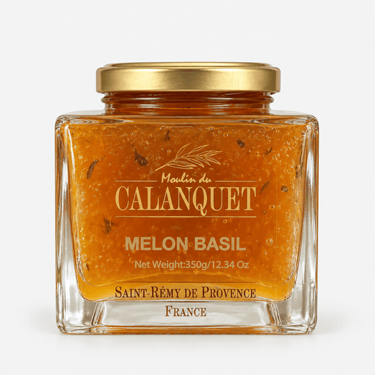 Moulin du Calanquet Melon & Basil Jam jar showing its vibrant color and herbs inside, perfect for cheese pairings.