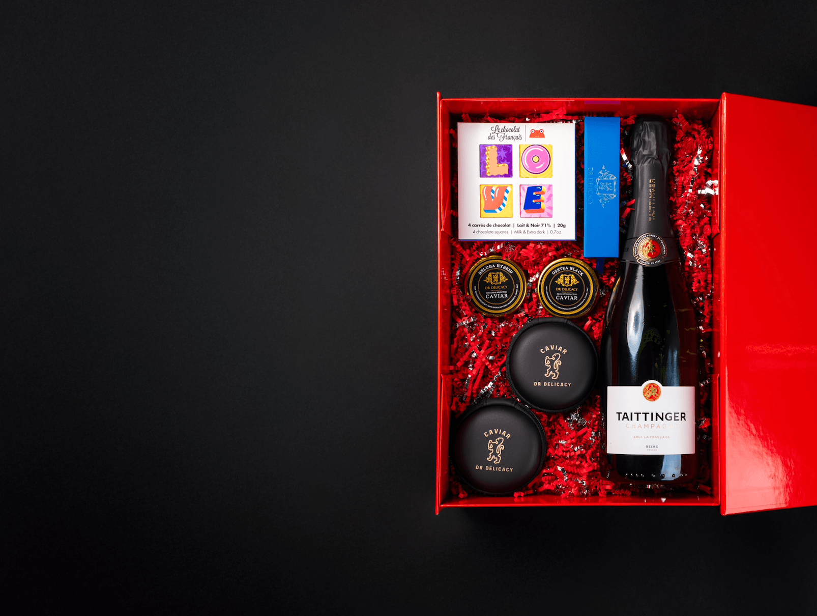 Luxury gift box featuring Taittinger champagne, gourmet treats, and a love-themed card, perfect for special occasions.