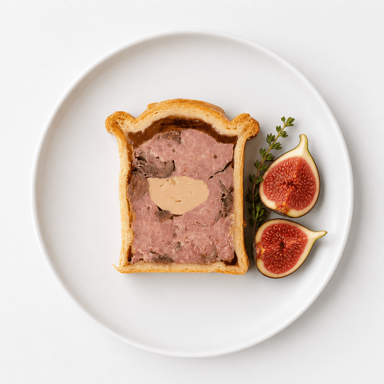 Dufour Pate en Croute with Duck and Figs showcasing flaky pastry, seasoned duck, and figs.