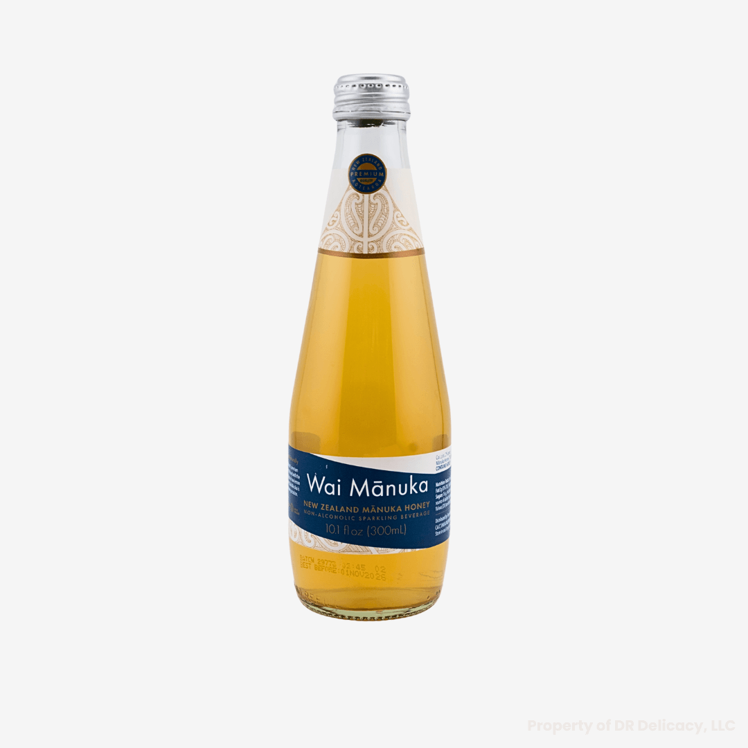 Wai Manuka Honey & Lemon Sparkling Water in a clear glass bottle, showcasing its refreshing golden hue.